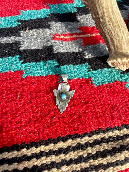 Silver arrowhead pendant with TQ